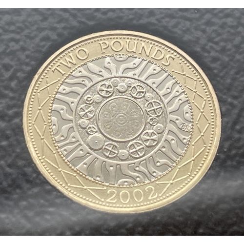 1199 - A cased proof set of 2002 British coins by The Royal Mint. To include Golden Jubilee crown and Stand... 