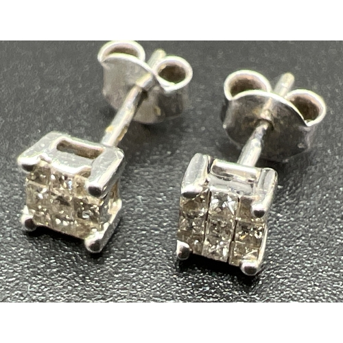9 - A pair of white gold and 0.5ct diamond square shaped stud earrings. Each earring set with 9 small sq... 