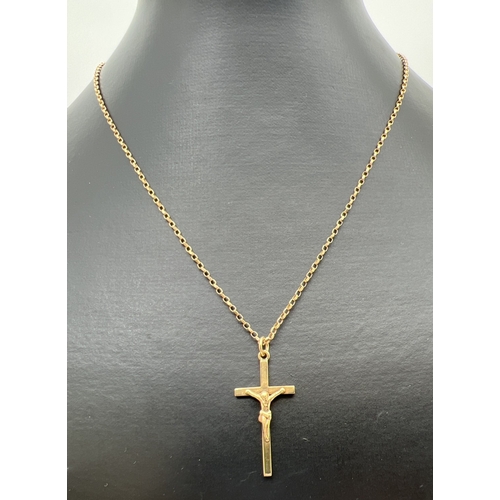 30 - A 9ct gold crucifix pendant on an 18 inch belcher chain with spring ring clasp. Gold marks to back o... 