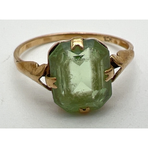 35 - A vintage 18ct gold dress ring set with an emerald cut green stone. Wear to stone. Size O½. Total we... 