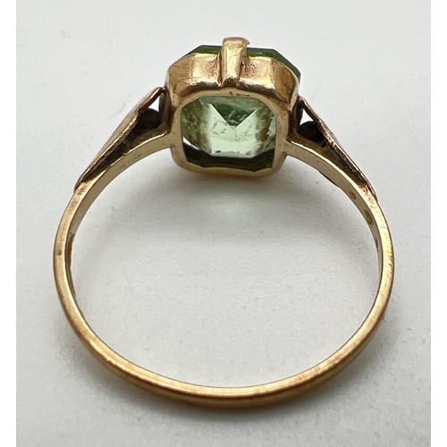 35 - A vintage 18ct gold dress ring set with an emerald cut green stone. Wear to stone. Size O½. Total we... 