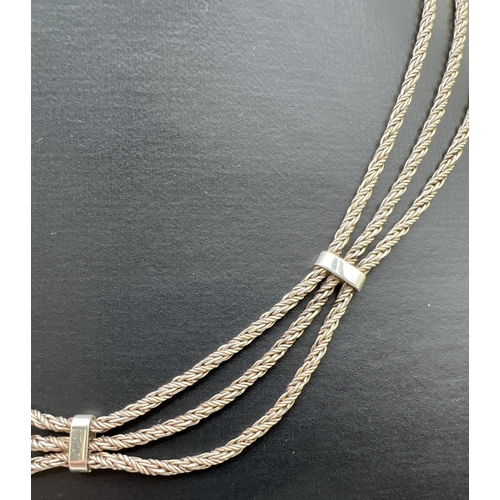 38 - A 16 inch silver triple row rope chain necklace with spring ring clasp. Silver marks to fixings. Tot... 