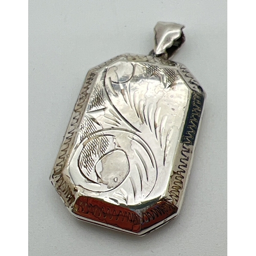 40 - A large octagonal shaped silver locket with engraved detail front and back. Silver marks inside. App... 