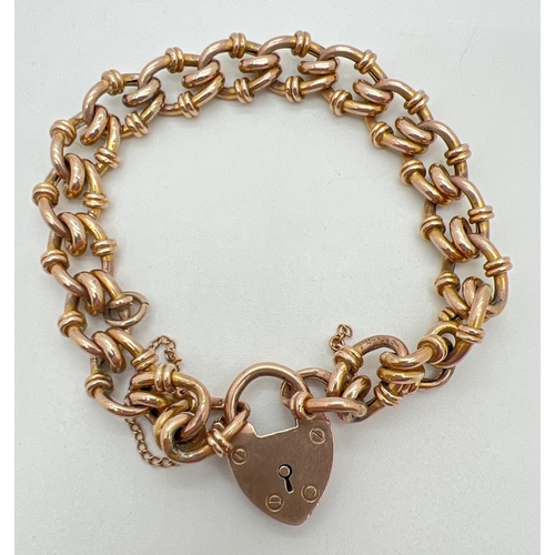 63 - An antique 9ct rose gold decorative link charm bracelet with padlock clasp and safety chain (broken)... 