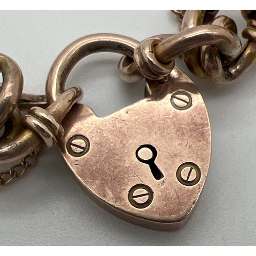 63 - An antique 9ct rose gold decorative link charm bracelet with padlock clasp and safety chain (broken)... 