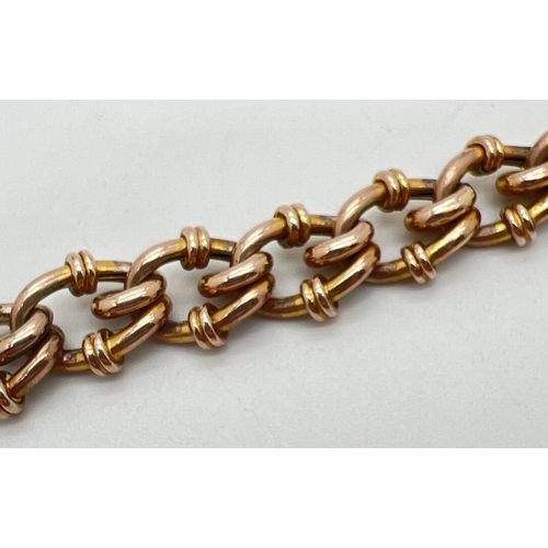 63 - An antique 9ct rose gold decorative link charm bracelet with padlock clasp and safety chain (broken)... 