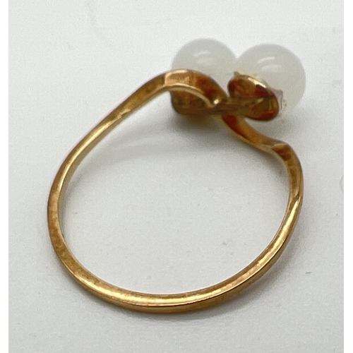 67 - A vintage 9ct gold double pearl twist deign ring. Both pearls are bead nucleus only, nacre layers ar... 