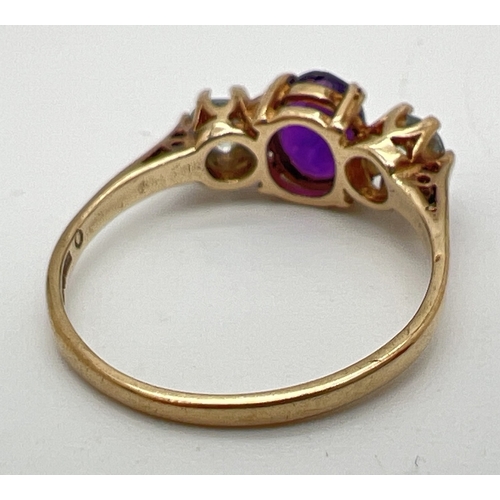 68 - A 9ct gold, amethyst and blue topaz ring with central oval cut amethyst and a round cut blue topaz t... 