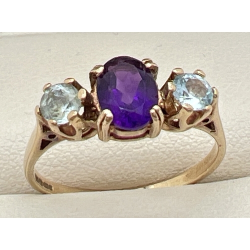 68 - A 9ct gold, amethyst and blue topaz ring with central oval cut amethyst and a round cut blue topaz t... 