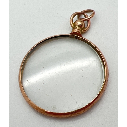 88 - A vintage 9ct rose gold framed glass locket with hanging bale, approx 3cm diameter. Hallmarks to bod... 