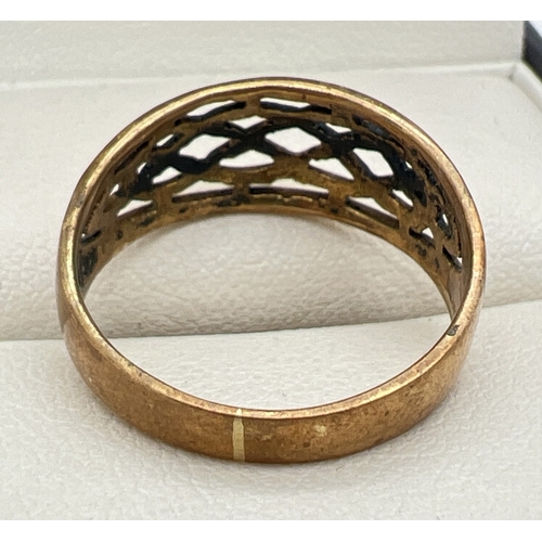 102 - A yellow gold Celtic design pierced work band ring. Unmarked but shows signs of resizing, tests as 9... 