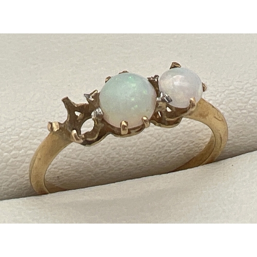 108 - An 18ct gold trilogy style dress ring set with opals - one stone missing. Gold mark inside band. Rin... 