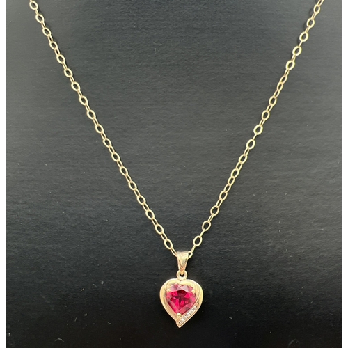 111 - A 9ct gold, ruby and diamond heart shaped pendant necklace. Pendant set with a heart shaped created ... 