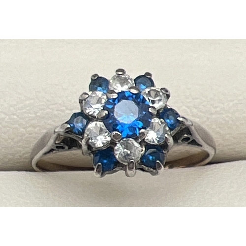 114 - A vintage 9ct gold and silver cluster style dress ring set with blue and white Spinel stones. Centra... 