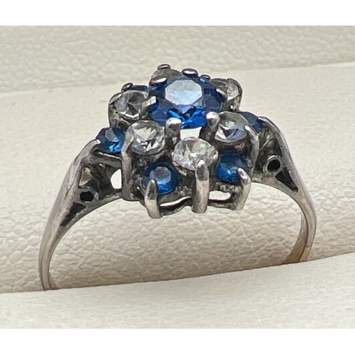 114 - A vintage 9ct gold and silver cluster style dress ring set with blue and white Spinel stones. Centra... 