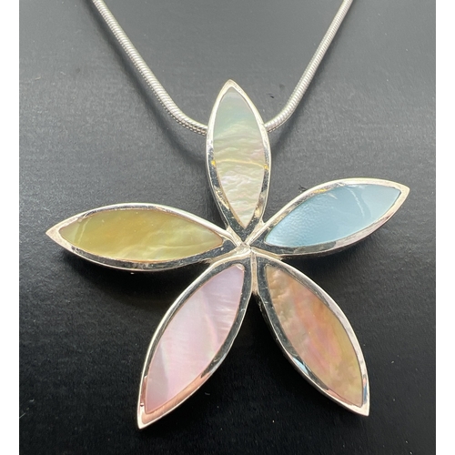 128 - A modern design silver flower shaped pendant set with different coloured mother of pearl, on an 18