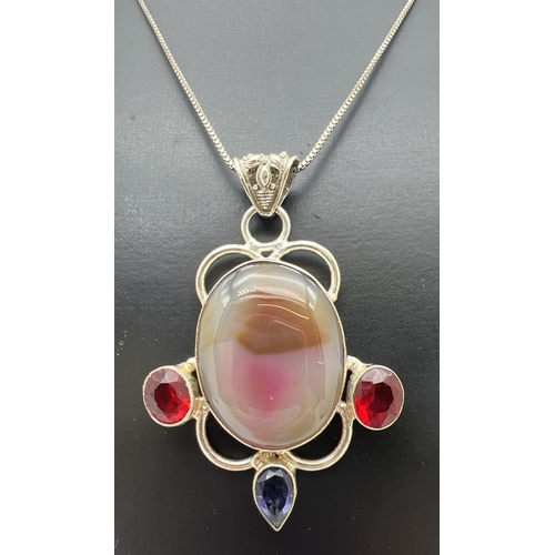 131 - A large modern design silver pendant set with agate and red & purple stones. With pierced work bale,... 