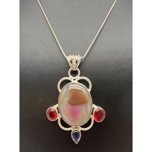 131 - A large modern design silver pendant set with agate and red & purple stones. With pierced work bale,... 