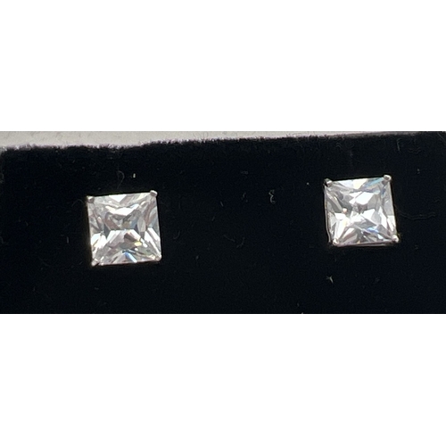 139 - A pair of modern design 9ct white gold square stud earrings each set with a square cut clear stone. ... 