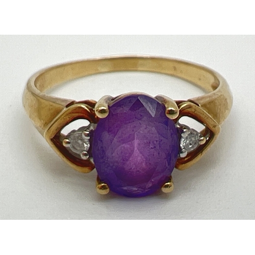 143 - A 9ct gold, amethyst and diamond ring with central oval cut amethyst and a small round cut diamond t... 