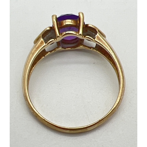 143 - A 9ct gold, amethyst and diamond ring with central oval cut amethyst and a small round cut diamond t... 