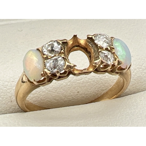 147 - A yellow gold opal and diamond Edwardian style dress ring. Set with 2 oval cut opals and 4 round cut... 