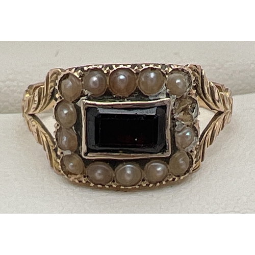 153 - A Victorian yellow gold, garnet and seed pearl ring. Central emerald cut garnet surrounded by 13 sma... 