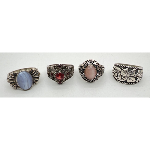 155 - 4 modern design silver rings. One set with garnets and marcasite stones, 2 with natural agates and a... 