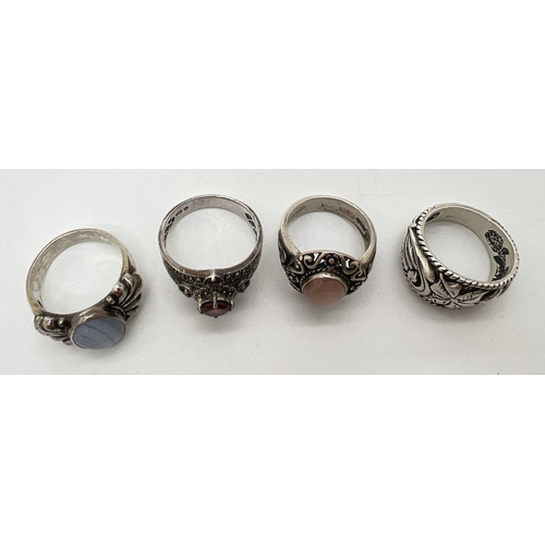 155 - 4 modern design silver rings. One set with garnets and marcasite stones, 2 with natural agates and a... 