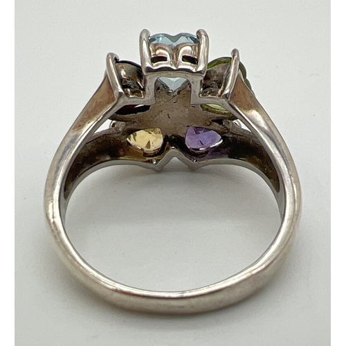 168 - A silver and multi gemstone flower design dress ring. Set with heart shaped cut citrine, amethyst, p... 