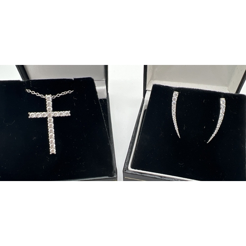 175 - 2 items of silver jewellery. A modern silver cross shaped pendant set with clear stones, on an 18