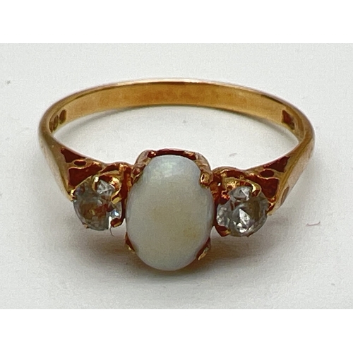 181 - A vintage 18ct gold opal and white topaz dress ring. Central oval cut opal flanked by a round cut wh... 