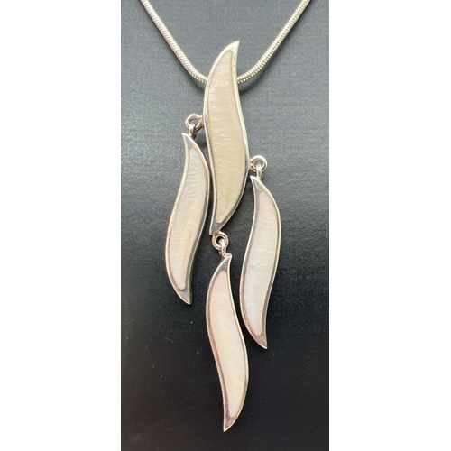 184 - A modern wave design silver pendant necklace and matching earrings, all set with white coloured shel... 