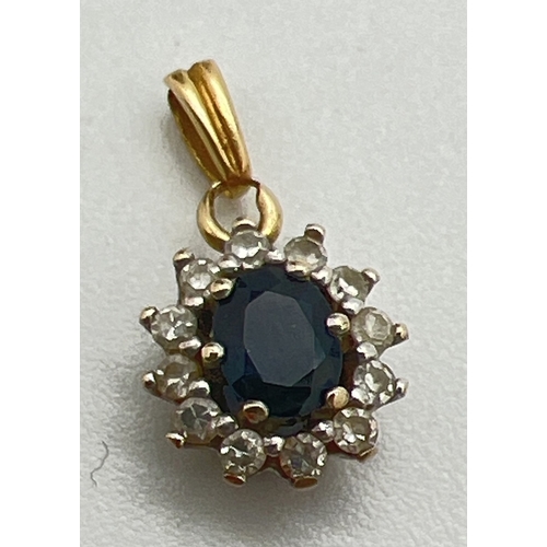 188 - A small 18ct gold pendant set with a central oval cut sapphire surrounded by 12 small round cut diam... 