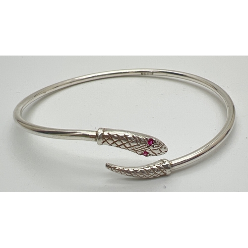 195 - A vintage silver serpent bangle with ruby set eyes. Full hallmarks inside of bangle for Birmingham 1... 