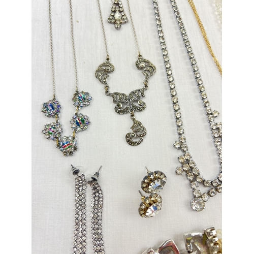 198 - A tray of vintage and modern diamante and stone set costume jewellery. To include necklaces, earring... 