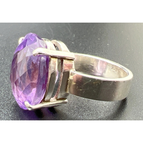 1099 - A modern design silver dress ring set with a checkerboard cut oval amethyst, stone approx. 1.75cm x ... 