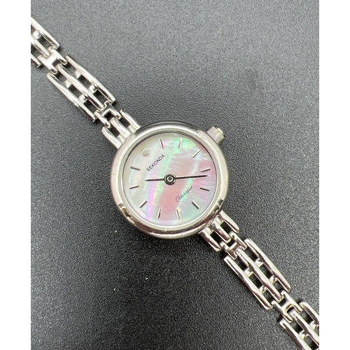 1143 - A 925 silver ladies wristwatch by Sekonda. Round mother of pearl face with clear stone at 12 hour ma... 