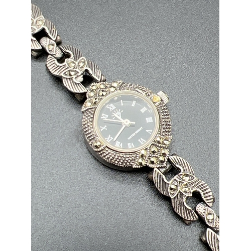 1146 - A ladies silver cocktail watch with floral detail and 3 marcasite stones to each links. Engine turne... 