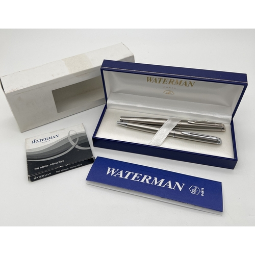 1203 - A boxed Waterman stainless steel cased pen set - fountain pen & ball point pen, together with a box ... 