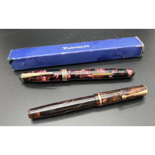 1204 - 2 vintage fountain pens. A pink marble effect pen by Osmiroid with decorative gold plated band to li... 