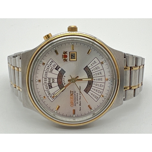 1114 - A men's automatic multi-year Calendar watch by Orient, BV0219. Silver and gold tone stainless steel ... 