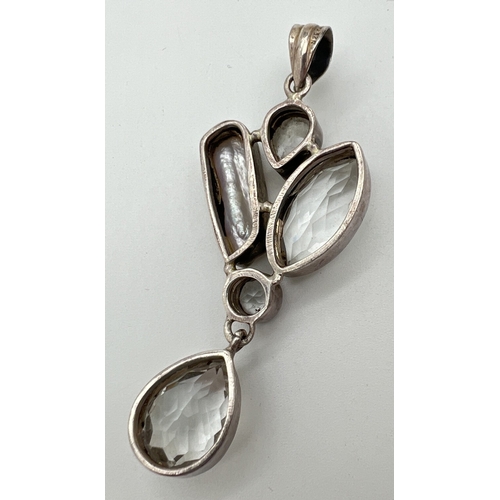 1015 - A large modern design silver pendant set with clear quartz, moonstone and a Keshi pearl. A marquise,... 