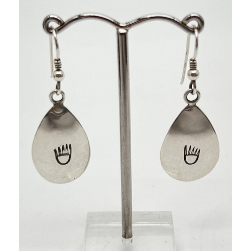 1017 - A pair of sterling silver Native American teardrop shaped earrings with bears paw print decoration, ... 