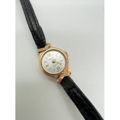 1129 - A ladies vintage 9ct gold cased wristwatch by Relide, with black leather strap. Hallmarked inside ca... 