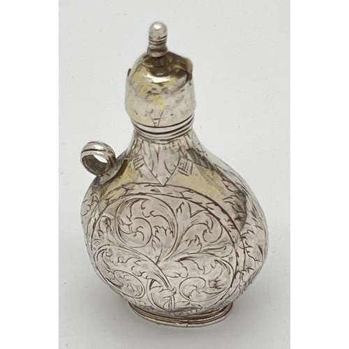 1156 - A late 17th Century silver scent flask of pilgrim form with engraved scene of Cupid to one side and ... 