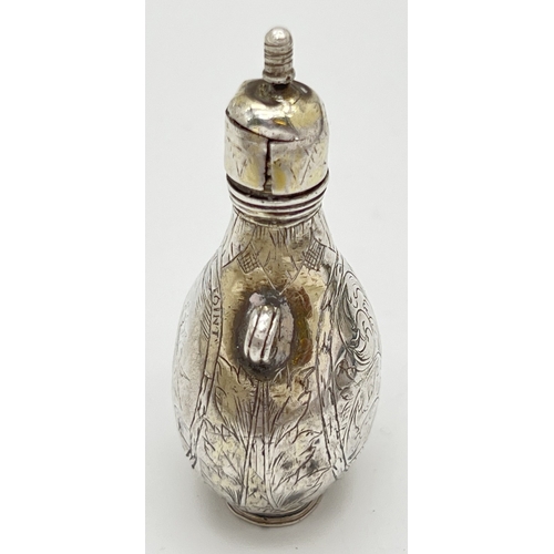 1156 - A late 17th Century silver scent flask of pilgrim form with engraved scene of Cupid to one side and ... 