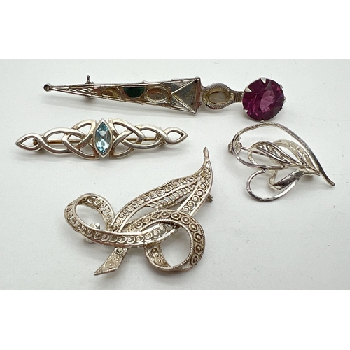 1063 - 4 silver brooches. A small intertwined heart brooch, a filigree leaf and bow brooch, a Scottish Edin... 