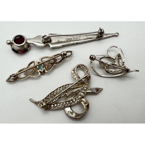 1063 - 4 silver brooches. A small intertwined heart brooch, a filigree leaf and bow brooch, a Scottish Edin... 