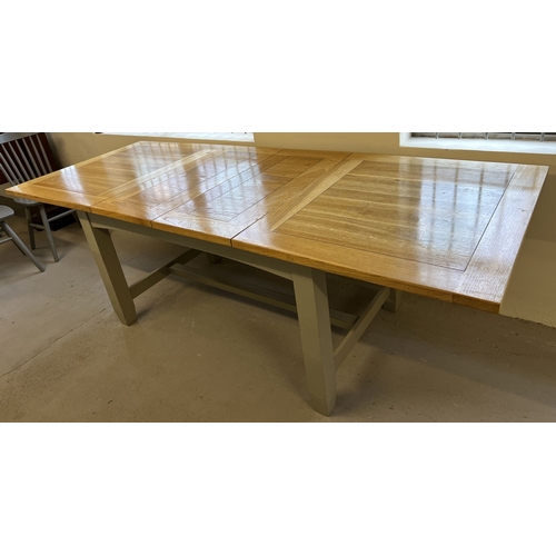 1357 - A modern pine dining table with natural wood finish top and grey painted base. Together with 7 grey ... 